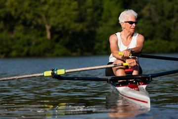 Senior woman rowing in rowing boat