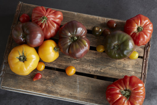 Selection of heirloom tomatoes on wooden board