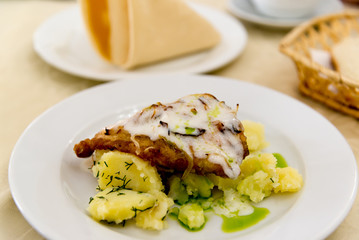 Boiled potatoes and cod in batter