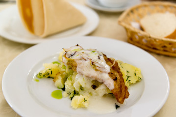 Boiled potatoes and cod in batter