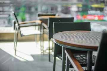 table and chair on terrace in urban blur view with sunlight