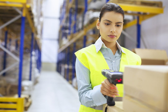 Young woman with barcode reader in distribution warehouse
