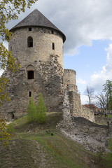Fototapeta na wymiar The tower of a medieval castle cloudy may afternoon. Cesis, Latvia