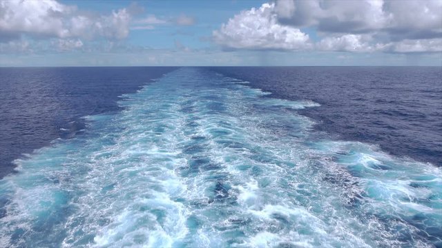 Wake of ship at sea in Atlantic Ocean with sky and horizon