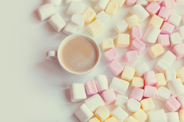 marshmallow and cup of coffee on the table