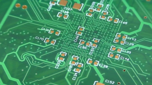 Printed circuit board rotation closeup green electronic background