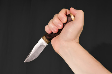 Man's hand holding knife