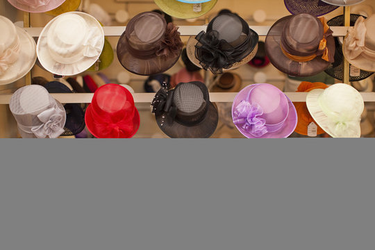 Rows of colorful hats in traditional milliners shop