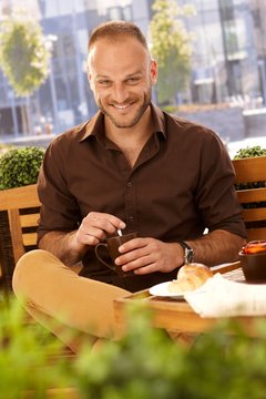 Outdoor photo of happy man with coffee