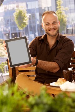 Happy man holding tablet with blank screen