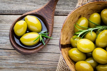 Zelfklevend Fotobehang Fresh olives and gray background. Olives in bowl and spoon. © gitusik