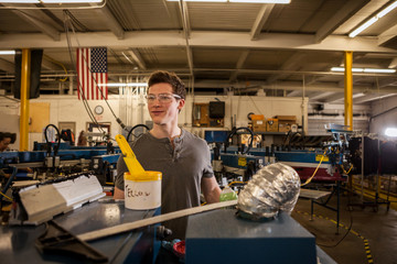 Worker operating machinery in factory