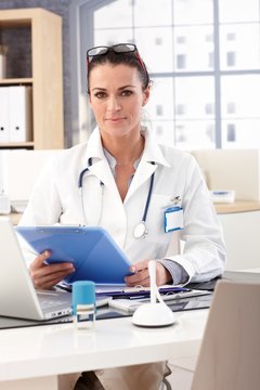 Female doctor sitting at medical office desk