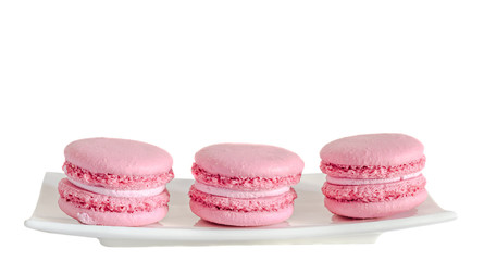 Pink sweet macaroons, french traditional, cream,  white plate, isolated.