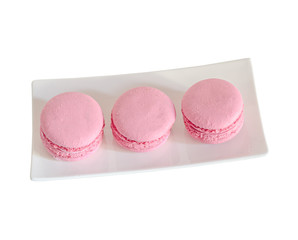 Pink sweet macaroons, french traditional, cream,  white plate, isolated.