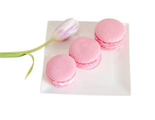 Pink sweet macaroons, french traditional, cream,  white plate, isolated.