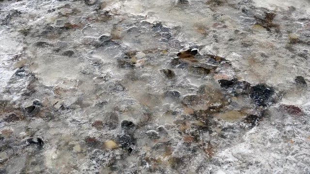 A magic of the winter. Melting ice. Flowing under the ice water.
