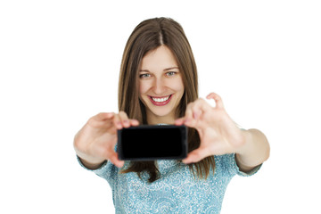 Fototapeta premium Young beautiful woman taking selfie with mobile phone