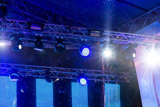 blue stage lights during the rain