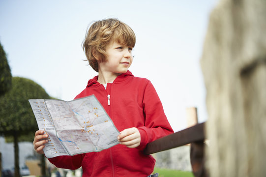 Young boy holding map in park, Province of Venice, Italy