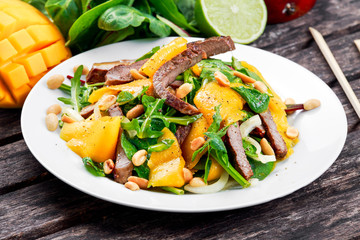 Fresh Tasty Mango, beef salad with vegetables and nuts.