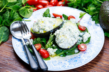 Avocado halves stuffed with cottage cheese and sunflower seeds