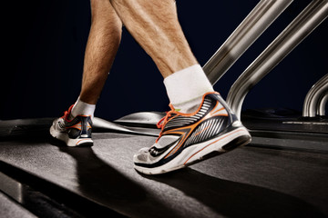 Close up of male legs running on gym treadmill in altitude centre