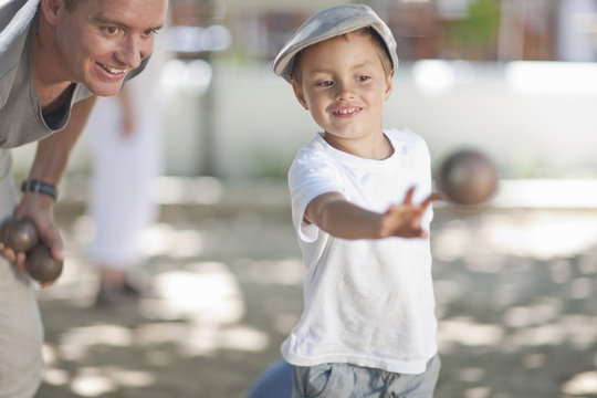 Father and son playing boules