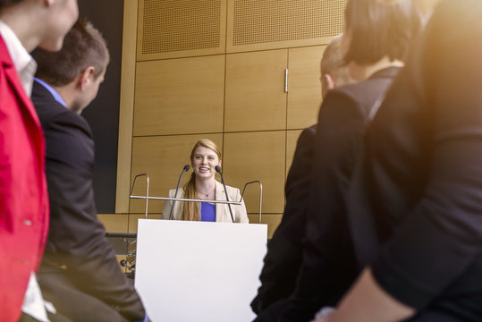 Young Businesswoman Speaking To Audience In Conference Room