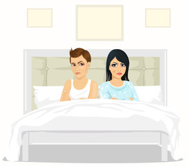 couple with arms folded looking arguing at each other over shoulder sitting on bed