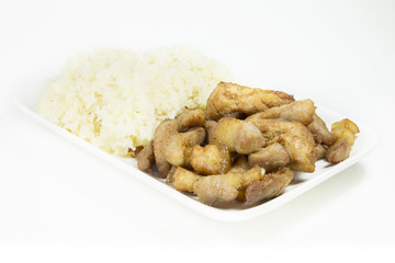 Fried pork with sticky rice on white dish on white background.