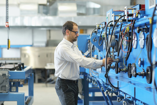 Manager monitoring industrial machinery