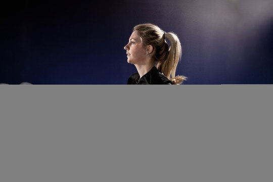 Young woman running on treadmill at gym in altitude centre