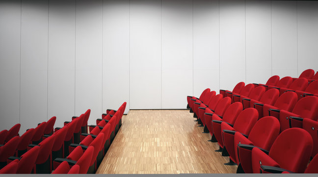 Red chairs in empty auditorium