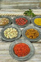 Spices and herbs in metal bowls. Food and cuisine ingredients.