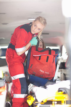 Paramedics in ambulance checking equipment