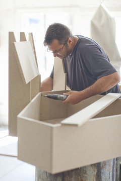 Upholsterer drilling furniture box frame