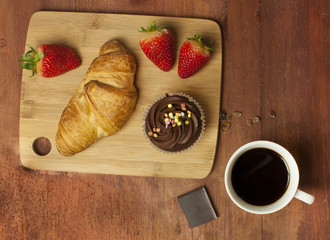Sweet breakfast photo: coffee, chocolate, strawberries, croissant...