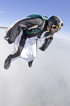 Mid adult man free falling in wingsuit preparing to fly