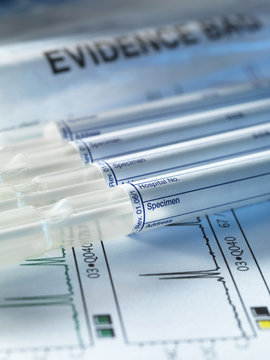 A row of samples from a crime scene on top of genetic testing results