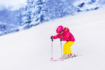 Little girl skiing in the mountains