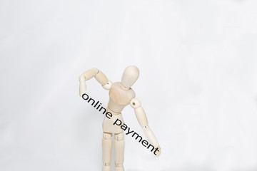 Hand writing online payment with wooden persona on transparent wipe board.