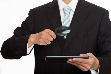 Auditor holding magnifying glass and tablet. Over blue background