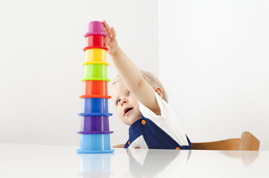 Little Boy Playing With Stacking Cups