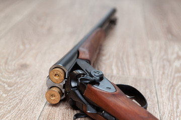  retro hunting gun with shotgun shells on wooden