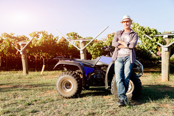 Man standing next to truck in vineyard