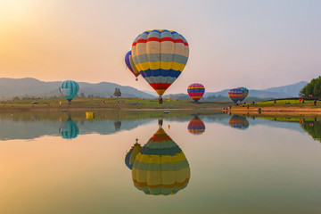 Hot air color balloon over lake with sunset time, Chiang Rai Province, Thailand