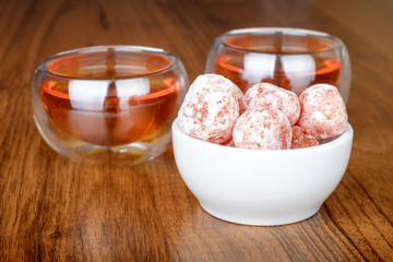 Tea in cups and kumquat