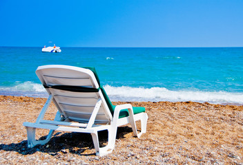 A chaise-longue on the beach.