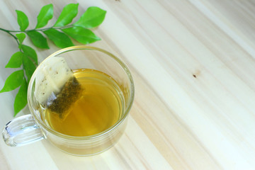 Hot tea with green leaves